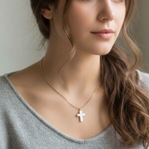 Silver cross on a gold chain necklace